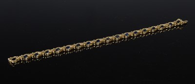 Lot 147 - A yellow metal, sapphire and diamond bracelet,...