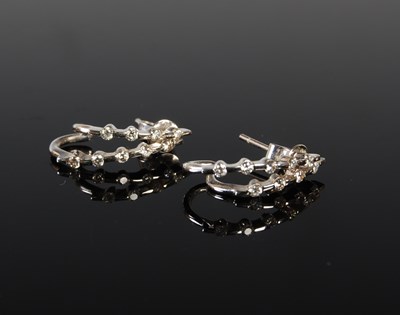 Lot 149 - A pair of white metal and diamond earrings,...