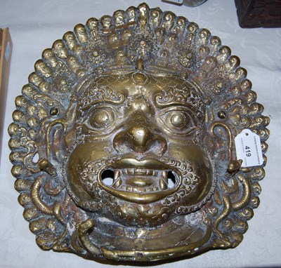 Lot 419 - An Indian brass Bhairava mask, 34cm x 33cm.