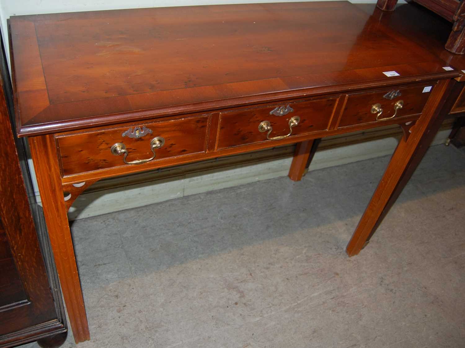 Lot 624 - A reproduction side table with three...