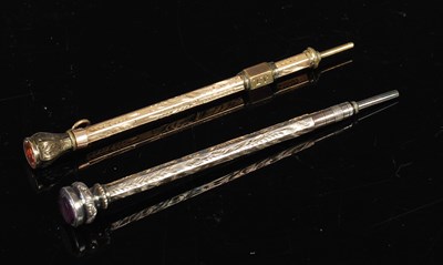 Lot 205 - A yellow metal propelling pencil and a white...