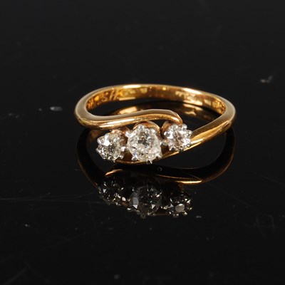 Lot 208 - A yellow metal and three stone diamond ring,...