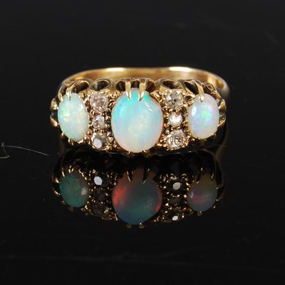 Lot 209 - A yellow metal, opal and diamond dress ring,...