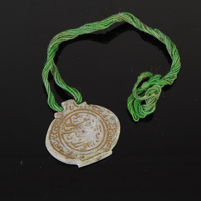 Lot 213 - A Persian green jade stone pendant with...