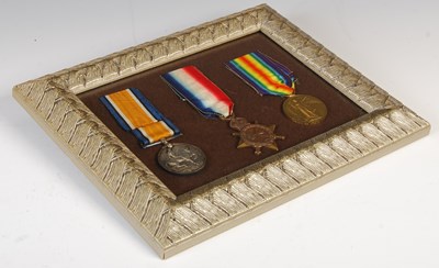 Lot 253 - A framed group of three Great War medals.