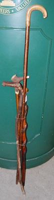 Lot 548 - An Irish bog oak walking stick, a walking...