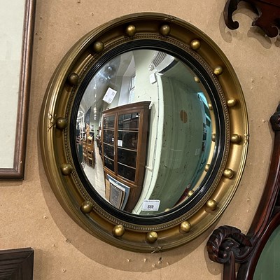 Lot 559 - A Regency style gilt circular convex mirror...