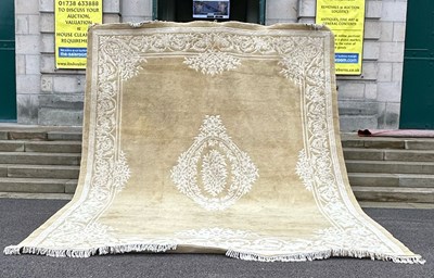 Lot 765 - A large 20th century beige ground carpet, the...