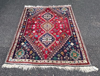 Lot 777 - A Persian rug, 20th century, the madder ground...