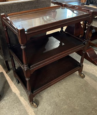 Lot 625 - A mahogany three tier tea trolley with...