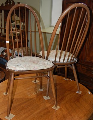 Lot 633 - A pair of dark stained Ercol dining chairs...