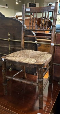 Lot 646 - A stained beech childs chair with woven rush...