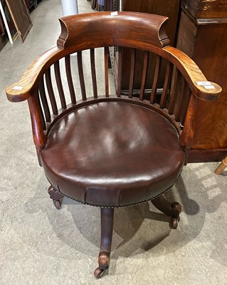 Lot 664 - An early 20th century revolving desk chair...