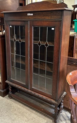 Lot 685 - An early 20th century oak and leaded glass two...