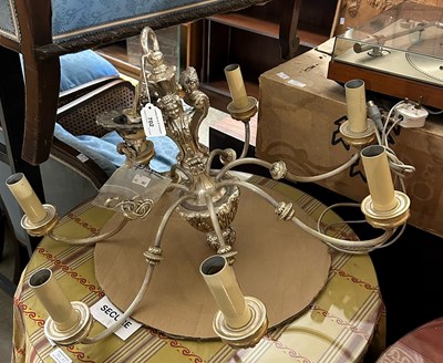 Lot 702 - A silvered metal seven light chandelier,...