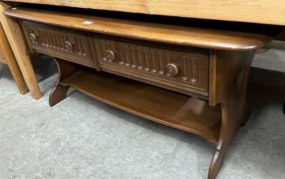 Lot 718 - An Ercol coffee table, the rounded rectangular...