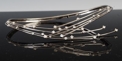 Lot 756 - An 18ct white gold and diamond set hinged...