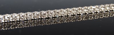 Lot 758 - An 18ct white gold and diamond tennis bracelet,...