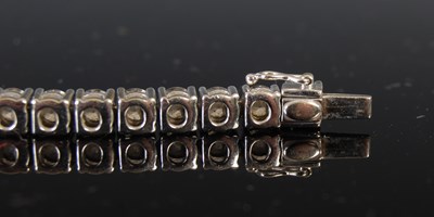 Lot 758 - An 18ct white gold and diamond tennis bracelet,...