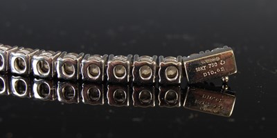 Lot 758 - An 18ct white gold and diamond tennis bracelet,...