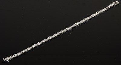 Lot 744 - A 9ct white gold and diamond tennis bracelet,...