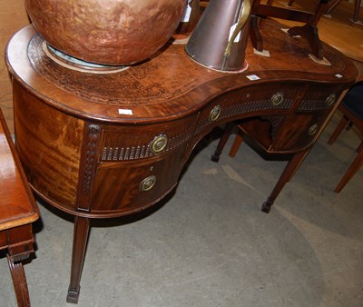 Lot 658 - A 20th century kidney-shaped desk with brown...