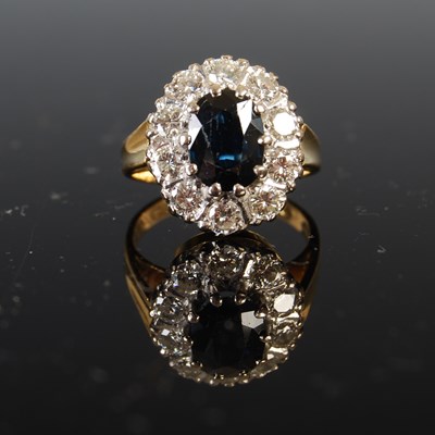 Lot 733 - A yellow metal, sapphire, and diamond oval...