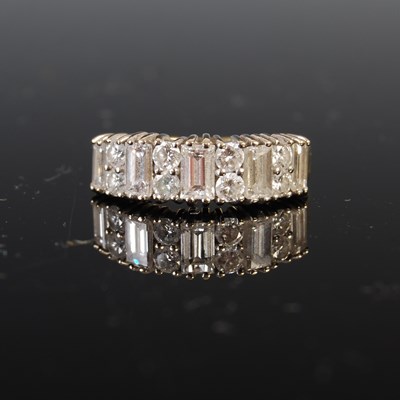 Lot 739 - An 18ct gold and diamond set eternity ring,...