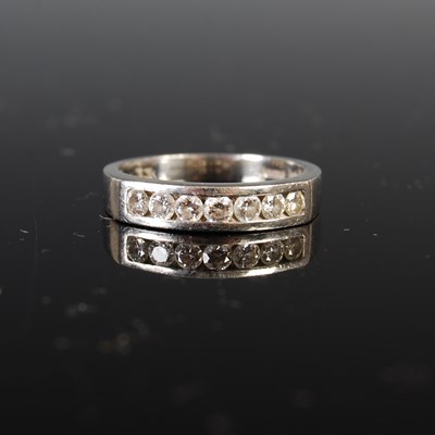 Lot 722 - A platinum and diamond half-hoop eternity ring,...