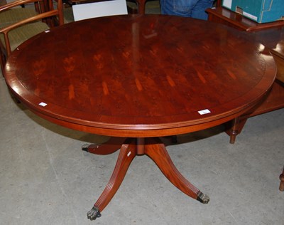 Lot 661 - A reproduction circular snap-top table.