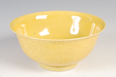 Lot 821 - A Chinese porcelain yellow ground dragon bowl,...