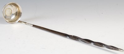 Lot 564 - An antique white metal toddy ladle, the bowl...