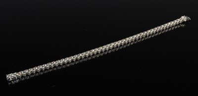 Lot 734 - An 18ct white gold and diamond tennis bracelet,...