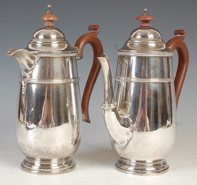 Lot 528 - A George V silver coffee pot and hot water pot,...