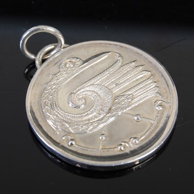 Lot 533 - A silver pendant cast and engraved to both...