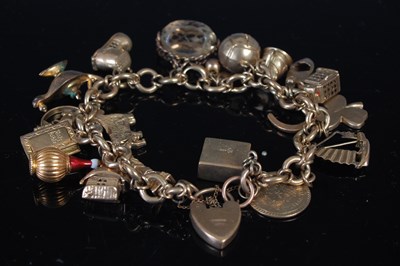 Lot 750 - A vintage 9ct gold charm bracelet, suspending...