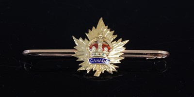 Lot 678 - A yellow metal and enamel Canada lapel badge...