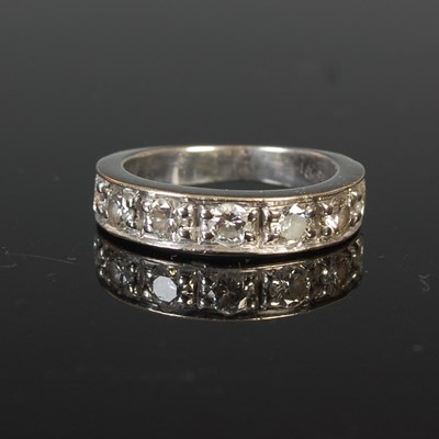 Lot 725 - A white metal and diamond half hoop ring, set...