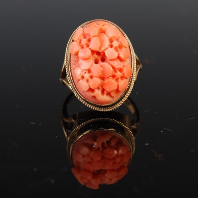 Lot 651 - A 9ct gold and red coral dress ring, the oval...