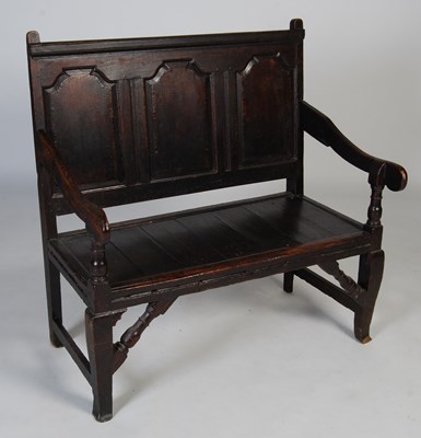 Lot 94 - An 18th century carved oak hall bench, the...