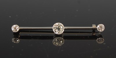 Lot 707 - An Edwardian diamond three-stone bar brooch,...