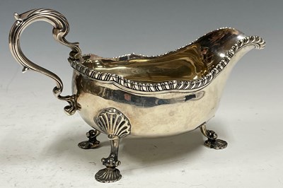 Lot 547 - A George III large silver sauceboat, on three...