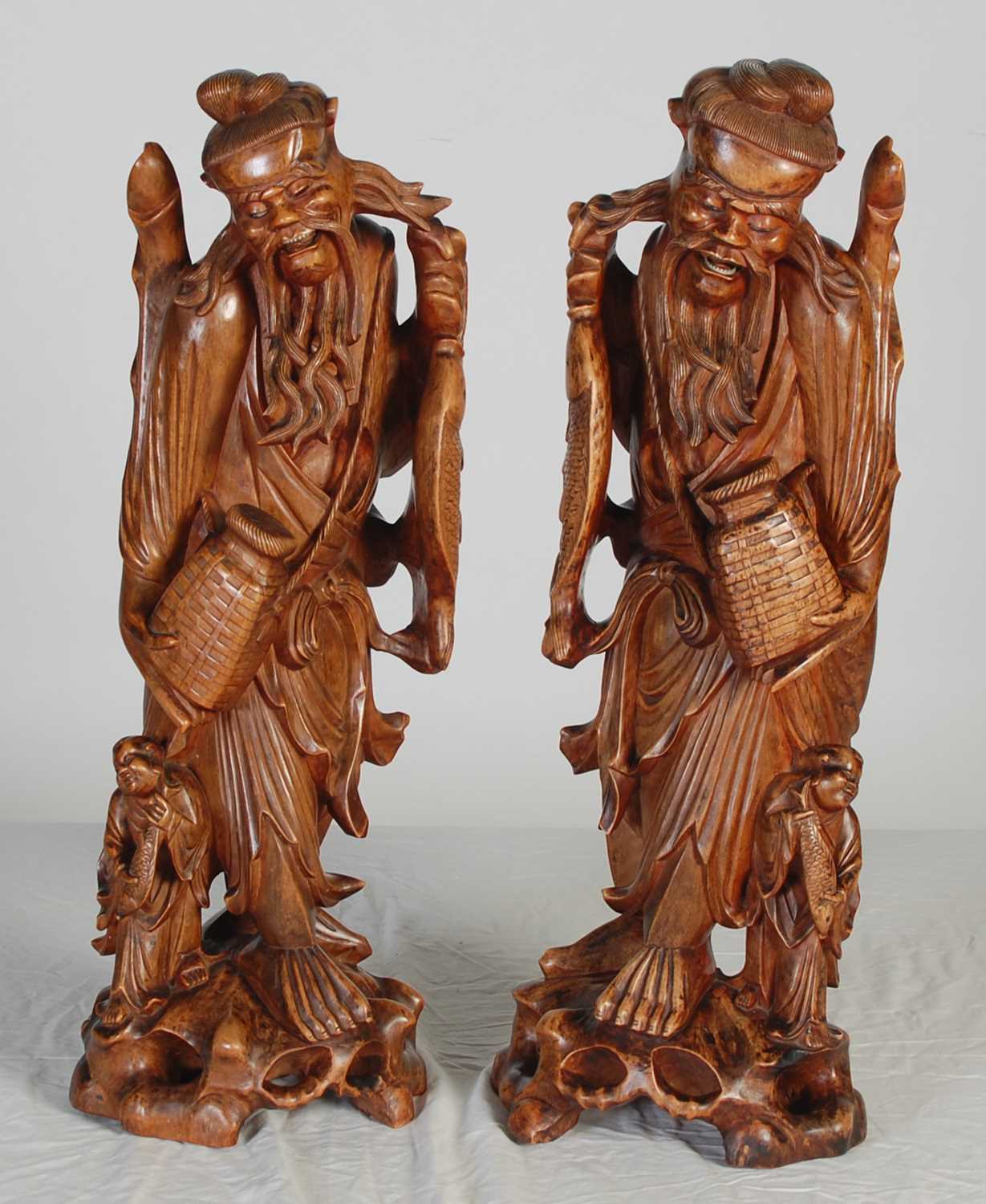 Lot 844 - A pair of Chinese carved wood figures of...