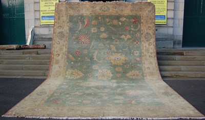 Lot 164 - A large Persian green ground carpet, the...