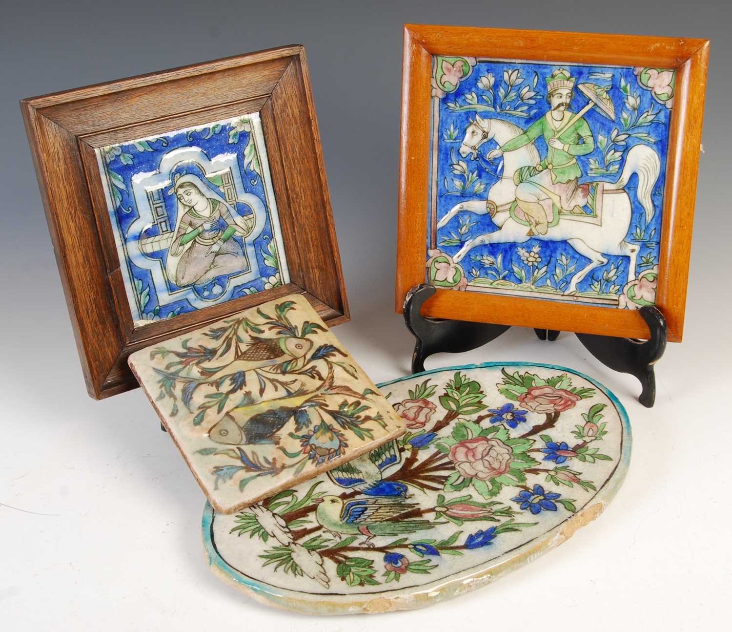 Lot 887 - A group of four Persian Qajar pottery tiles,...