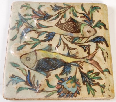 Lot 887 - A group of four Persian Qajar pottery tiles,...