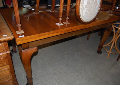 Lot 708 - An early 20th century walnut extending dining...