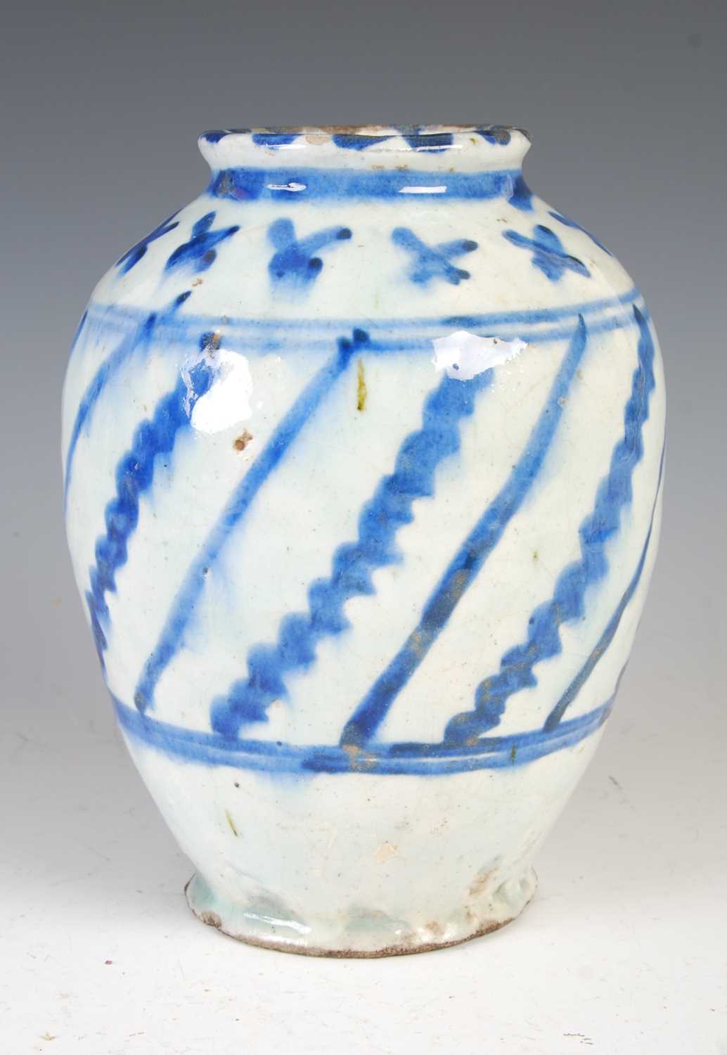 Lot 879 - A Persian pottery blue and white vase, 19th...