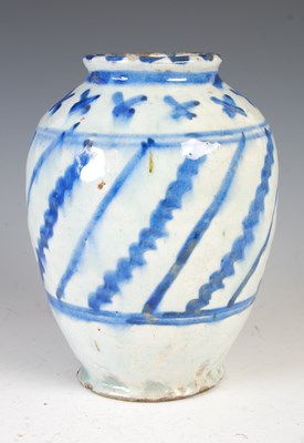Lot 879 - A Persian pottery blue and white vase, 19th...