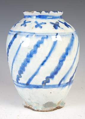Lot 879 - A Persian pottery blue and white vase, 19th...